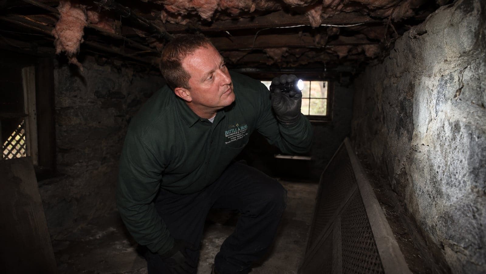 Battle A Bug technician performing cricket inspection and treatment at a Long Island home